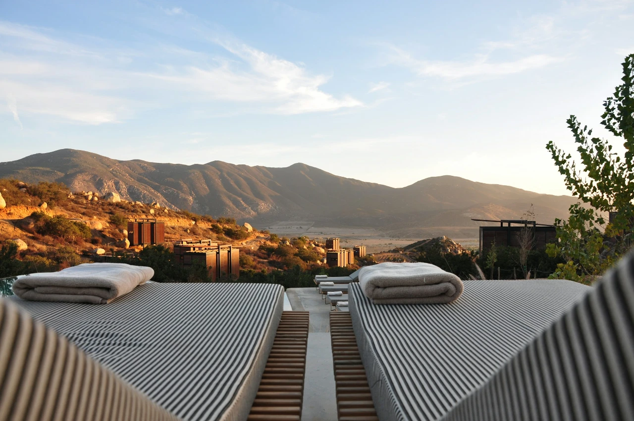 Dachterrasse eines Hotels mit Liegen und Bergpanorama